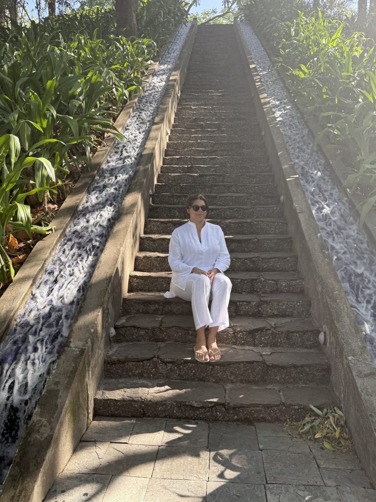 Liv on the water-channel steps in the gardens at Ananda