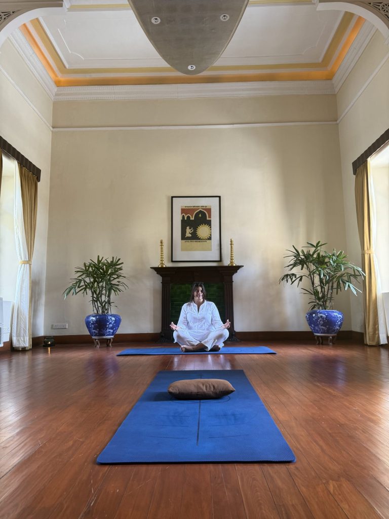 Liv meditating in the palace yoga hall at Ananda in the Himalayas
